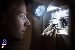 Man restoring power on circuit breaker after electricity outage