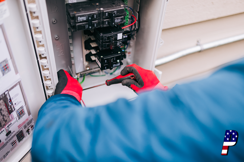 A gloved hand opening an outdoor electrical breaker.