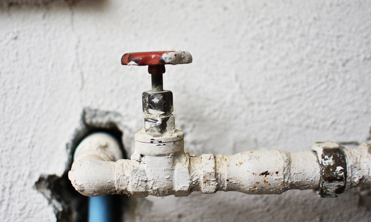 An old outdoor valve and faucet